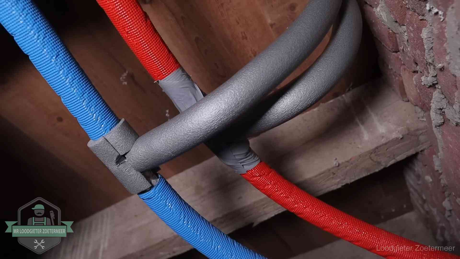 Bevroren leidingen voorkomen in Zoetermeer Geïsoleerde waterleidingen langs houten balken tegen bevriezing in Zoetermeer